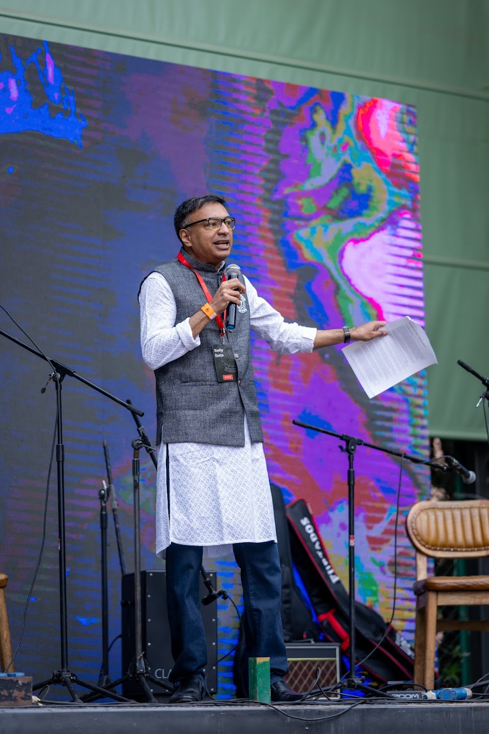 Sudip Dutta on stage telling a story to an audience
